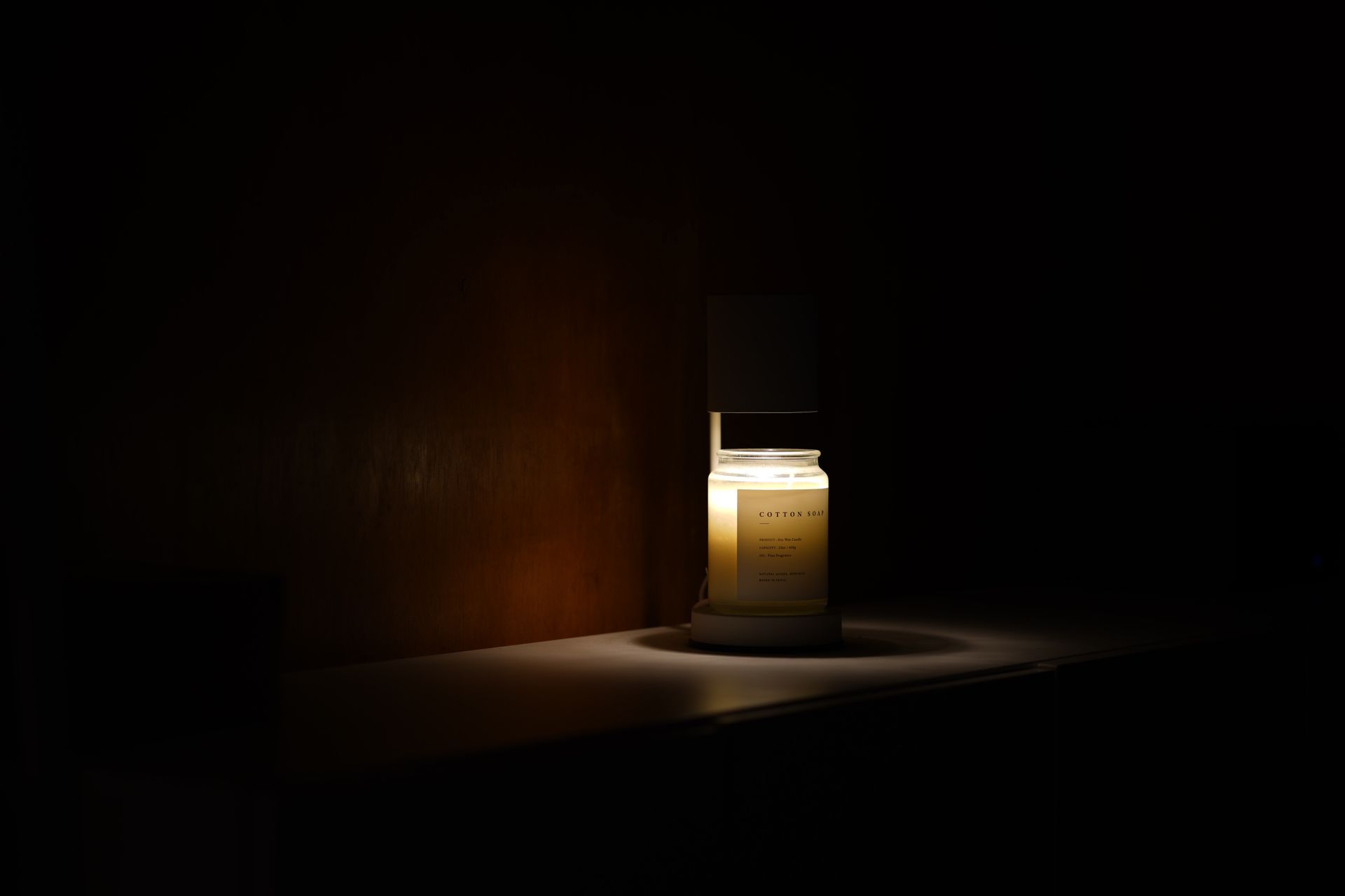 Lit candle in the dark